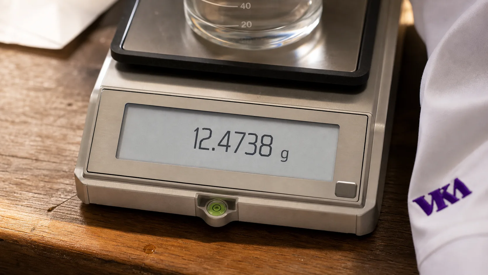 A flavourist weighs out actives on the analytical balance for a functional brief.